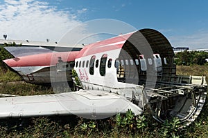 Plane fuselage wreckage sitting on the ground