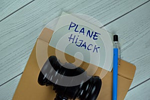 Plane Hijack text on document above brown envelope with gavel