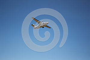 The plane hovering in the blue sky.