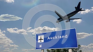 Plane landing in Auckland New Zealand airport with signboard