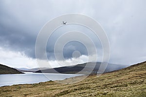 Plane landing in Faroe Islands, Vagar airport, Sorvagsvatn Leitisvatn lake in the rain, Northern Europe