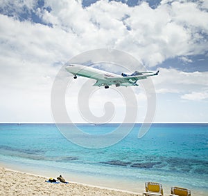 Plane landing over Maho Beach in Saint Martin island photo