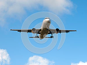 Plane landing on a sunny day with blue sky