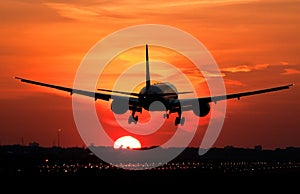 Plane landing in sunrise photo