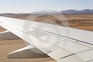The plane lands on the airfield. Spoilers and flaps trailing edge when landing. photo