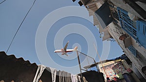 The plane lands low over the slums of the city of Mumbai.