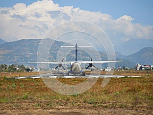 A plane of local, Nepalese airlines on the runway of the airport in Pokhara