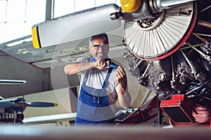 Plane Maintenance Engineer Repairing Engine