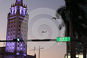 Plane over Freedom Tower at Miami Dade College at night