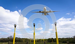 Plane over runway, Manchester Airport, England