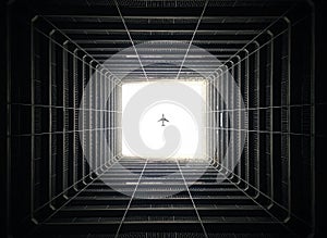 Plane Overhead Through Dark Building Atrium, Hong Kong