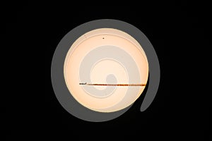 Plane passing the sun