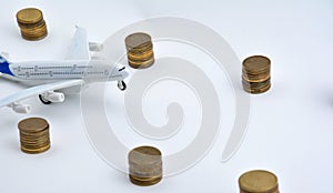 Plane plastic toy with coins isolated on white