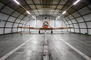 Plane on repair in a big hangar. Single turboprop aircraft in big hangar