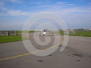 Small plane on the runway, airplane barn