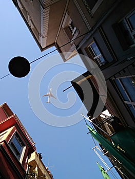 Plane in the sky over the streets of Balat