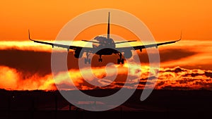 Plane spotting at Otopeni airport during sunset with red sky photo