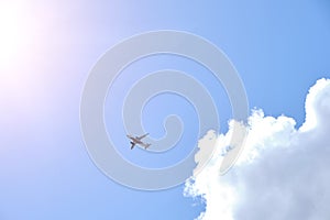 Plane takes gainst background blue sky and white clouds photo