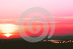 Plane takes off from runway on the background of sunset, toned