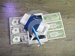 Plane tickets, passports and toy plane on table