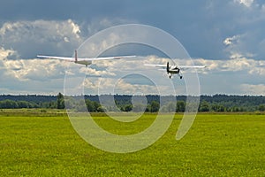 Plane towing a glider during takeoff from airfield