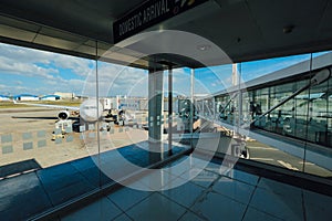 Plane which is boarding through the gate captured from the inside on an airport