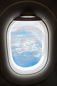 Plane window with cloud view aboard