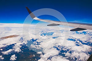 Plane wing above the clouds. Plane flying over the clouds