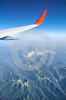 Plane wing on the background of Western Caucasus mountains. Adygeya, Russia