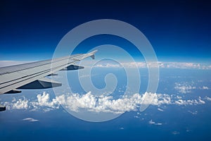 Plane wing on clear blue sky background