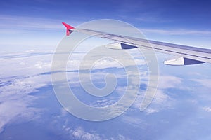 Plane wing flying over blue sky white cloud