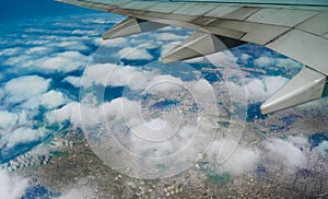 Plane wing over clouds