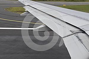 Plane wing on a runway before take off.