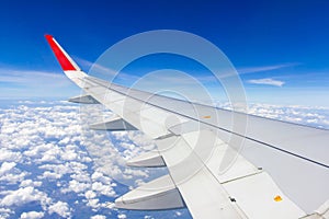 Plane wings over the sky and white clouds View from inside the plane