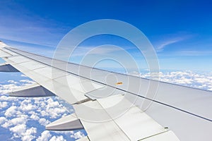 Plane wings over the sky and white clouds View from inside the plane