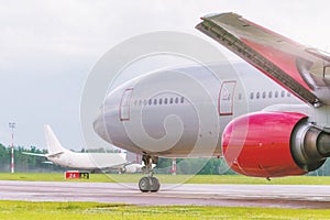 The planes lined up on the taxiway, awaiting clearance from the control tower. The main character of the photo, an