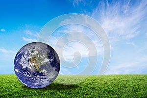 Planet earth beautiful on green grass with cloud sky, world with conservation