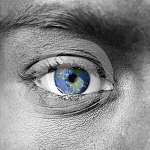 Planet earth in blue human eye