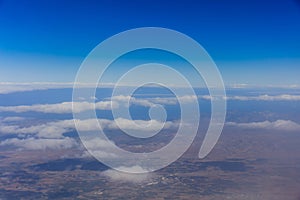 Planet earth. Blue sky, white clouds, land. View from above.