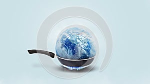 Planet earth burns in a frying pan on a gas burner on a blue background, concept. Global warming and climate change, creative idea