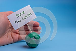 the planet earth in danger concept. earth holding a banner