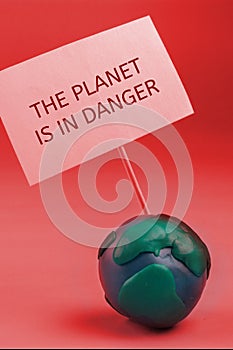 the planet earth in danger concept. earth holding a banner