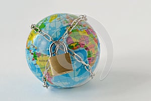 Planet earth locked with chain and padlock on white background - Concept of global security