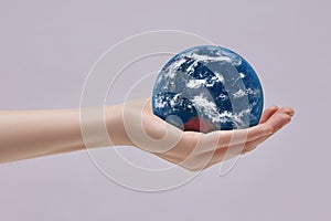 Planet Earth in palm of your hand. Concern for the environment and ecology. Elements of this image are furnished by NASA