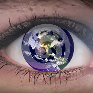Planet earth reflecting in a blue human eye close up image