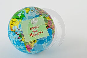 Planet earth with sticky note with the written Save the Planet on white background - Concept of ecology and enivironmental