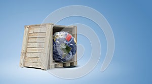 planet Earth in wooden crate with Fragile label stuck on it - 3D render