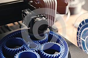 planetary gear machine part is made from blue plastic by a 3D-printer.