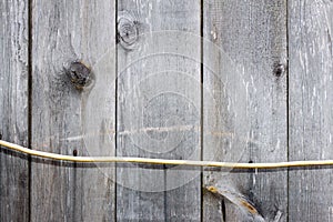 Plank (board) and electric cable. Old and cracked.