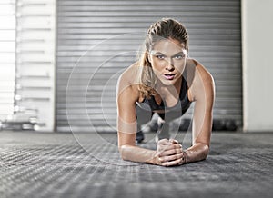 Plank, body fitness and portrait of woman in gym for exercise, training or workout practice for healthy wellness. Face